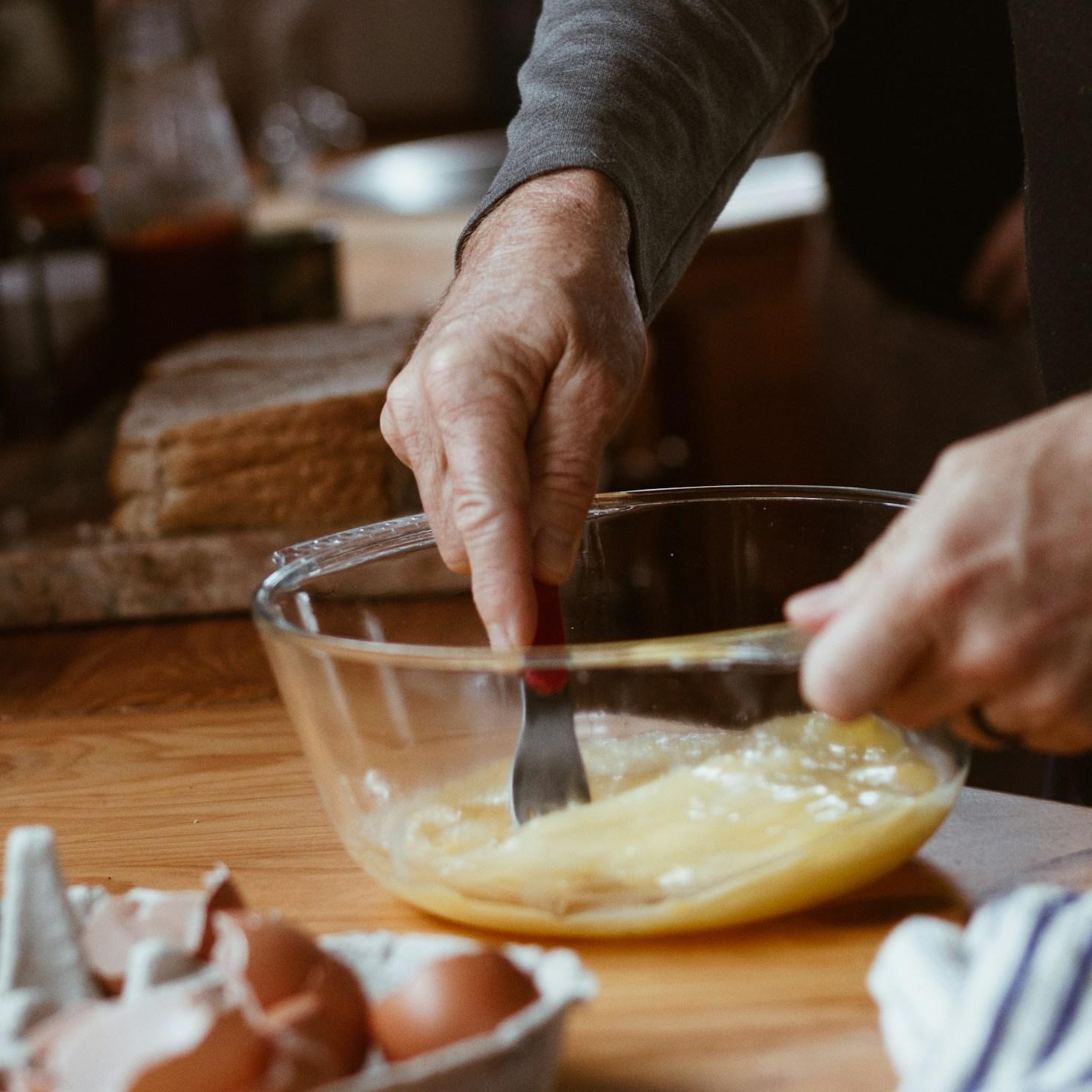 Community members collaborating in a modern kitchen space, exchanging recipes and cooking techniques